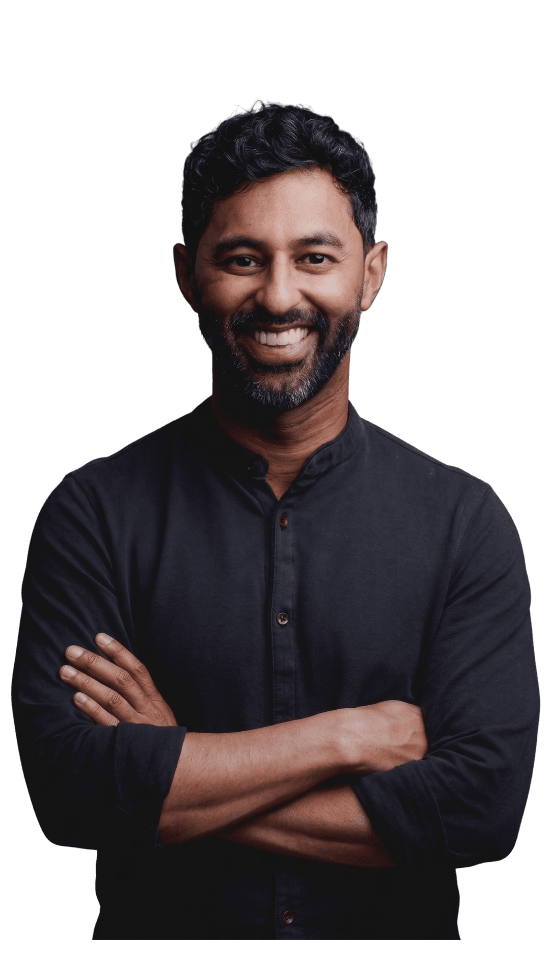 Ben Comstock, arms crossed, in a dark collarless shirt, smiling.